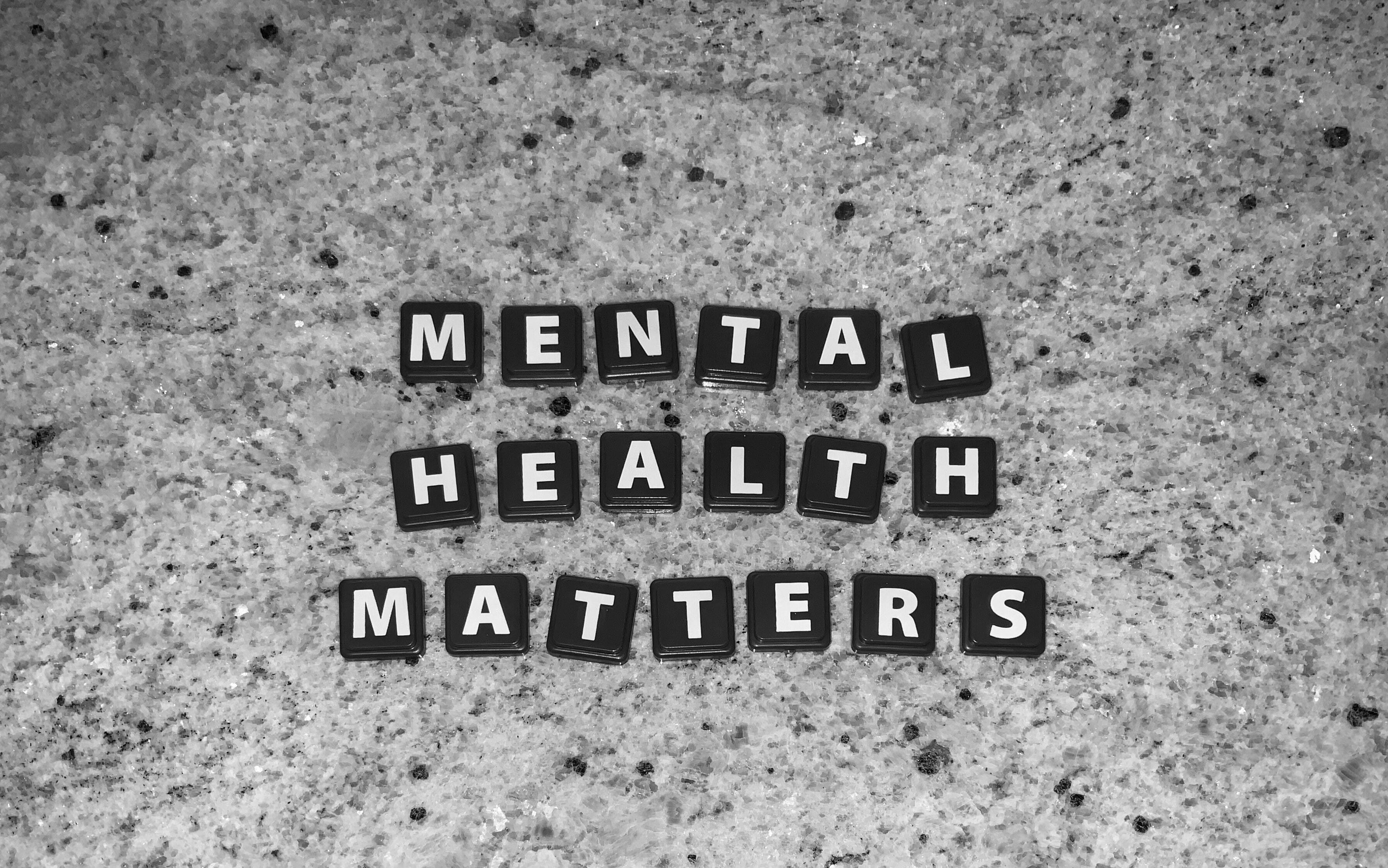 Grey stone tabletop with cube block letters reading Mental Health Matters